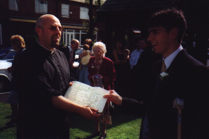Fr Philip hands over the Marriage Certificate.jpg 103.6K